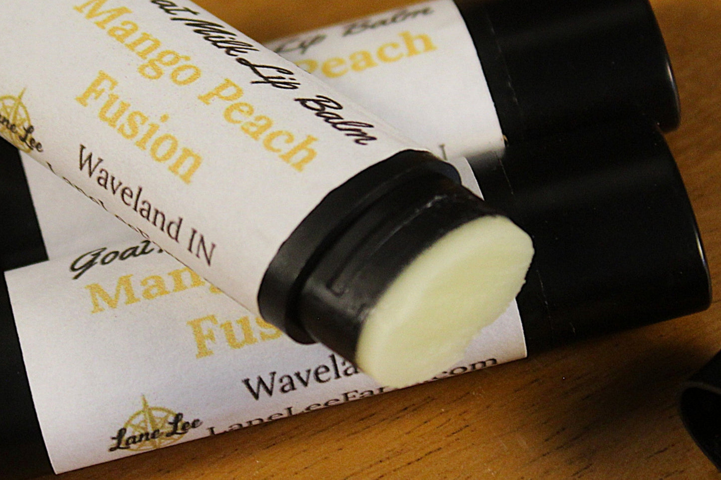 Lip balm with visible branding on a wooden surface