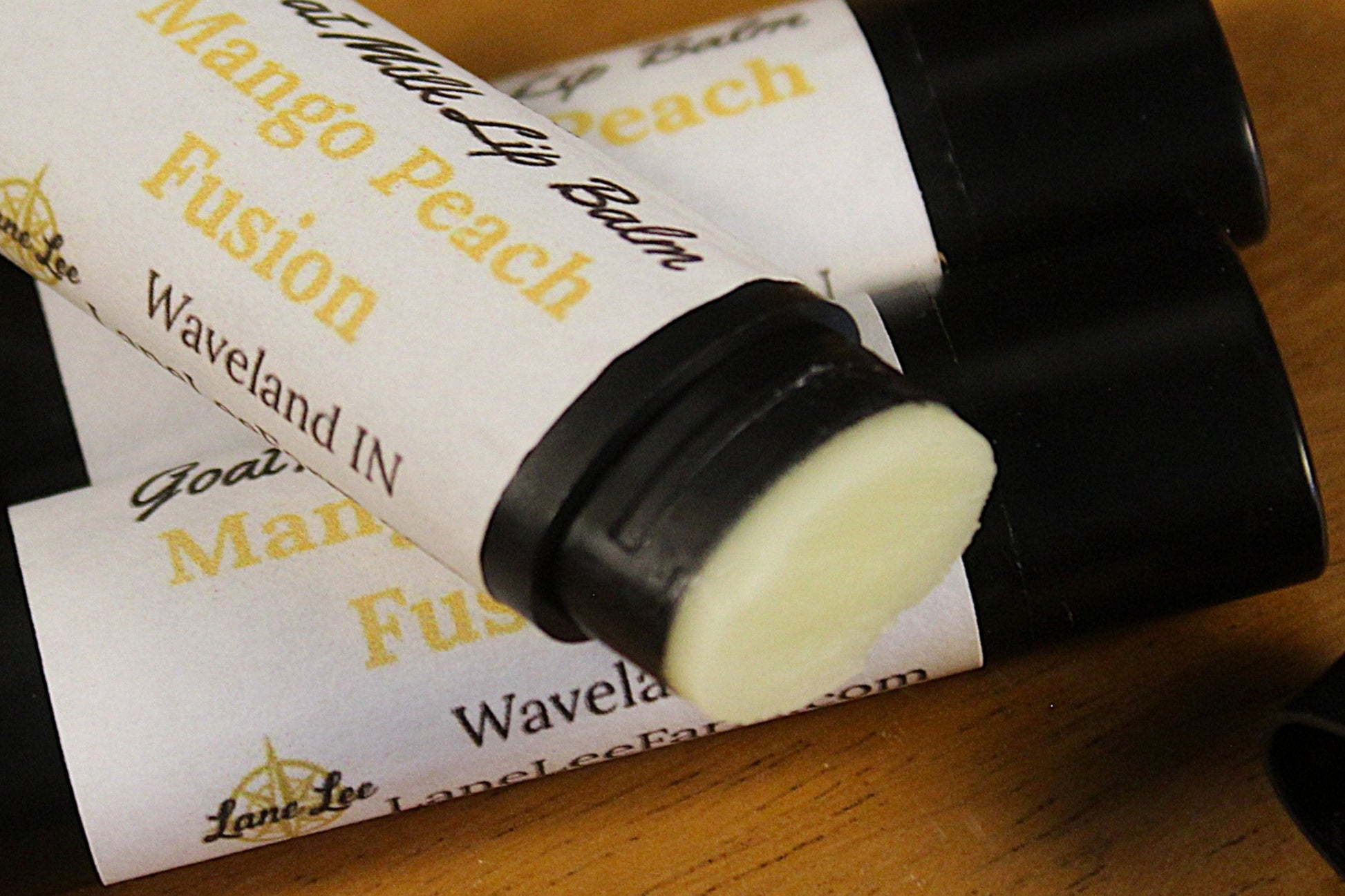 Lip balm with visible branding on a wooden surface